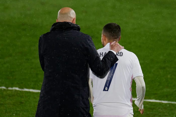 Manager Zinedine Zidane pictured (left) with his arm around Eden Hazard during a UEFA Champions League game between Real Madrid and Chelsea in April 2021